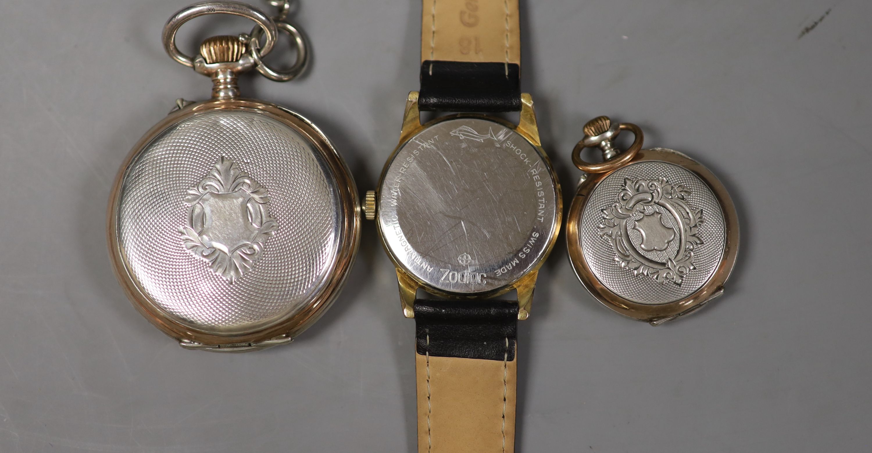 A Swiss silver pocket watch, a silver fob watch and a Zodiac wrist watch.